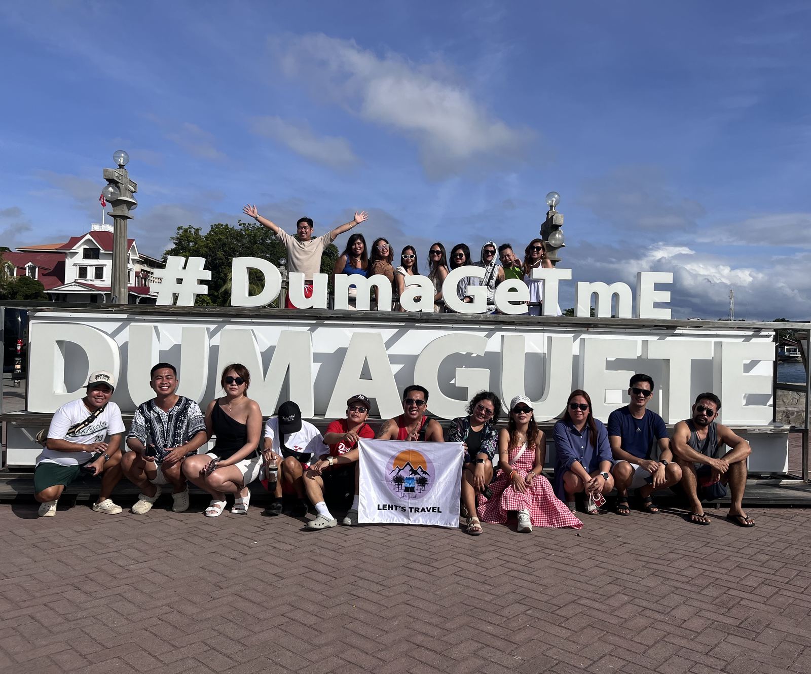Leht's Travel group at the Dumaguete sign